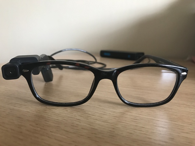 Photo shows an OrCam attached to a pair of glasses